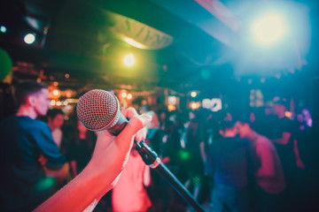 Wall Mural - Public performance on stage Microphone on stage against a background of auditorium. Shallow depth of field. Public performance on stage.