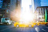 Fototapeta  - Yellow Taxi Cabs in New York city with bright sun shining