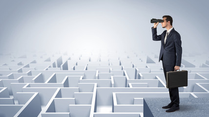 Wall Mural - businessman standing on maze and looking forward to the future concept