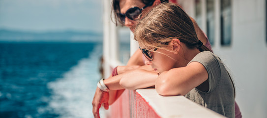 Mother and daughter traveling on a ferry boat