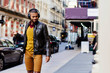 © Carlos David - Portrait of a young man waking on the street enjoying music, New York City