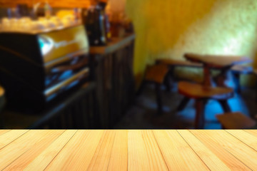 empty wooden table on on coffee shop background, with copy space