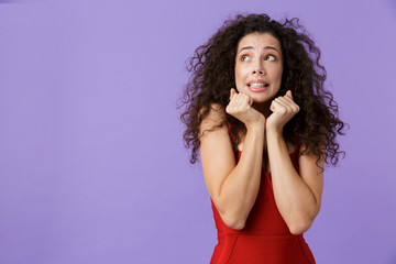 Wall Mural - Portrait of a scared woman with dark curly hair