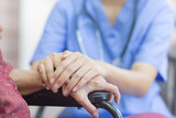 Hand of  eldery  woman with her caregiver at home. Home care or Elderly care concept.