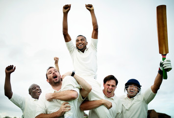 Cheerful cricketers celebrating their victory