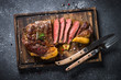 Grilled beef steak ribeye on wooden cutting board. 
