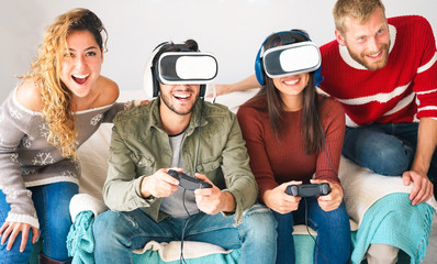 Group of millennials friends playing video games with virtual reality headset - Young people having fun with new vr trend technology - Tech, generation z, youth concept - Focus on left girl