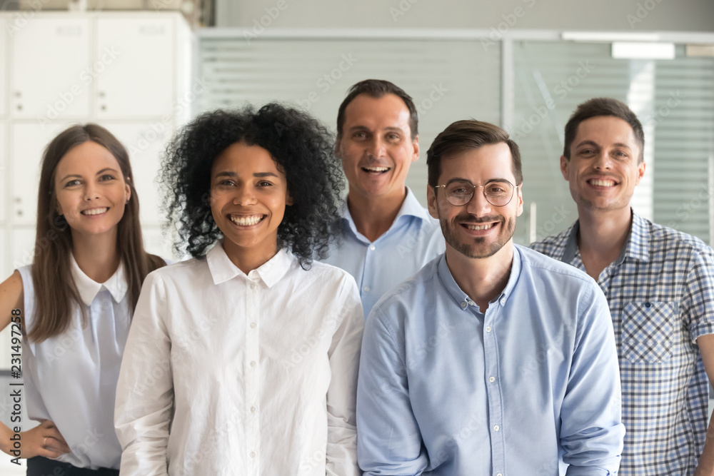 Smiling diverse office workers group, happy multiracial professional members employees looking at camera, motivated staff business people posing together, multi-ethnic workforce sales team portrait - obrazy, fototapety, plakaty 