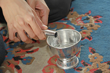 Pouring water from bottle into cup for share good .