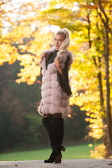 Beautiful stylish woman pose in park in early autumn