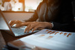 © boonchok - Hands of business women are using her laptop to communicate with customers via email.
