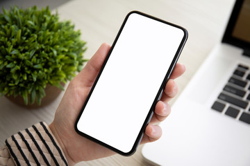 female hands holding touch phone with isolated screen in office