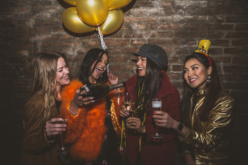 Wall Mural - Group of girls celebrating and having fun the club. Concept about women night out