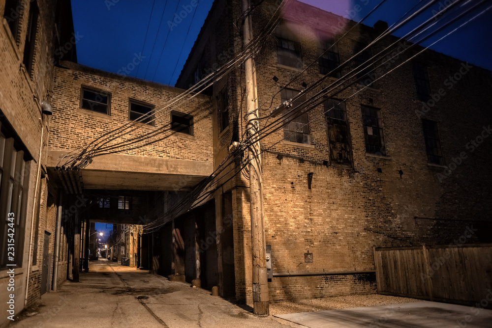 Dark and scary downtown urban city street alley scene with an eerie ...