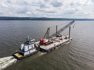 Tug boat pushing the cargo on the river