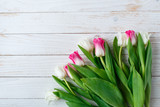 Fototapeta Tulipany - Pink adn White Tulips on white wooden background