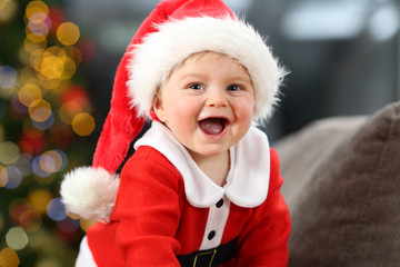 Kid wearing santa costume looking at you