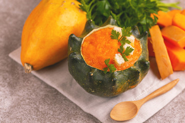 Wall Mural - Bright tasty pureed pumpkin soup served in a hollowed pumpkin