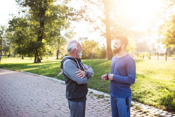 Happy father and son enjoying in walk outdoors in park.