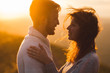 © Oleg Breslavtsev - Gentle close-up portrait of man and woman together, happy, looking at each other. Silhouette at beautiful sunset light, wind in hair