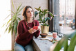 © zinkevych - Sweater and necklace. Beautiful successful freelancer wearing dark red sweater and necklace having lunch