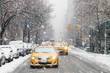 Taxis drive down a snow covered 5th Avenue during a winter nor'easter storm in New York City