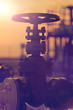 © ionutanisca - Oil and gas industrial pipe line valve at sunset