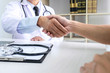 Professor Doctor having shaking hands with patient after recommend treatment method while discussing explaining his symptoms or counsel diagnosis health, healthcare and assistance concept