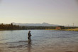 © goodluz - Fisherman flyfishing in river of Idaho state