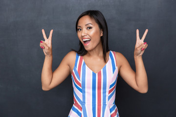 Poster - Portrait of a cheerful casual asian woman standing