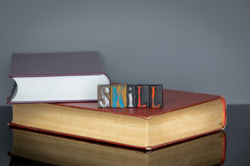 Wall Mural - Skill word from colored wooden letters on gray background. Education and knowledge concept