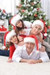 © aletia2011 - Portrait of happy family posing near Christmas tree
