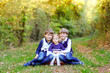 © Irina Schmidt - Portrait of three siblings children. Two kids brothers boys and little cute toddler sister girl having fun together in autumn forest. Happy healthy family playing, walking, active leisure on nature