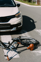 close up view of broken bicycle and car on road, car accident concept