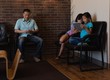 © Wavebreak Media - Father using mobile phone while daughters using digital tablet
