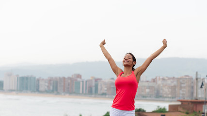 Wall Mural - Successful sporty woman towards city scape