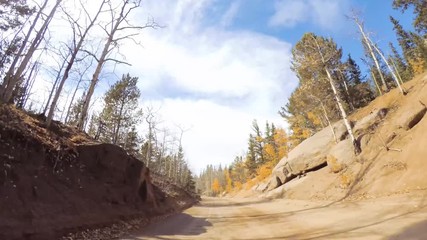 Sticker - Driving on small mountain dirt roads from Colorado Springs to Cripple Creek in Autumn.