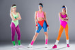 © LIGHTFIELD STUDIOS - full length view of athletic young women in 80s style sportswear posing on grey
