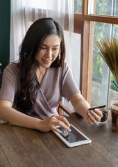 Sticker - happy woman using credit card to shopping online with tablet at cafe