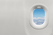 © charnsitr - Isolated airplane window with blue sky