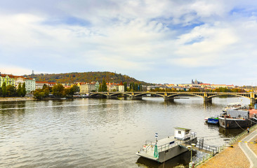 Wall Mural - City view from bridge and traditional Czech architecture of antique Prague buildings at autumn evening.