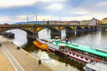 Wall Mural - City view from bridge and traditional Czech architecture of antique Prague buildings at autumn evening.