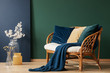 © Photographee.eu - Glass vases with flowers next to comfortable rattan settee with blue, emerald and beige pillows and blanket, real photo with copy space on empty green wall