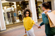 © BGStock72 - Young multiethnic couple with bags in the shopping