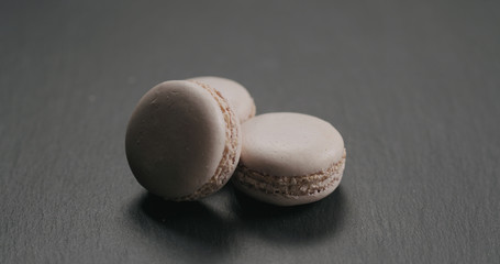 Wall Mural - Beige macarons on slate background