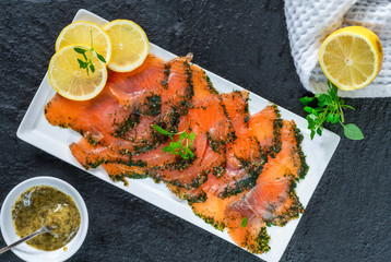 Poster - Gravadlax - Nordic dish of thinly sliced raw salmon cured in salt, sugar and dill and accompanied by dill and mustard sauce - top view