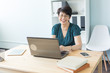 © satura_ - Business people and technology concept - Middle-aged woman working at laptop