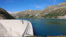 Arch dam (Kölnbreinsperre) in Austria (Kärnten) at 1.890 meters height. Beautiful blue lake with blue skies. Perfect scenery for hiking in the mountains. The lake is called Kölnbreinspeicher.