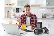© New Africa - Portrait of food blogger with laptop and camera in kitchen. Online broadcast
