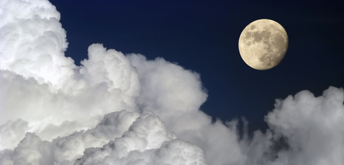 Wall Mural - moon and large clouds moonlit evening landscape with moon dark blue sky
